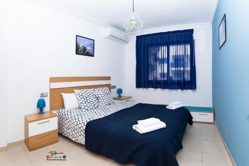 a bedroom with a bed with two towels on it at Apartament Solar in Alicante