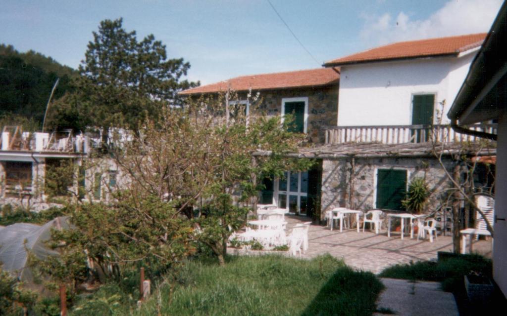 a stone house with a patio and a balcony at La Foce Del Prato in Framura