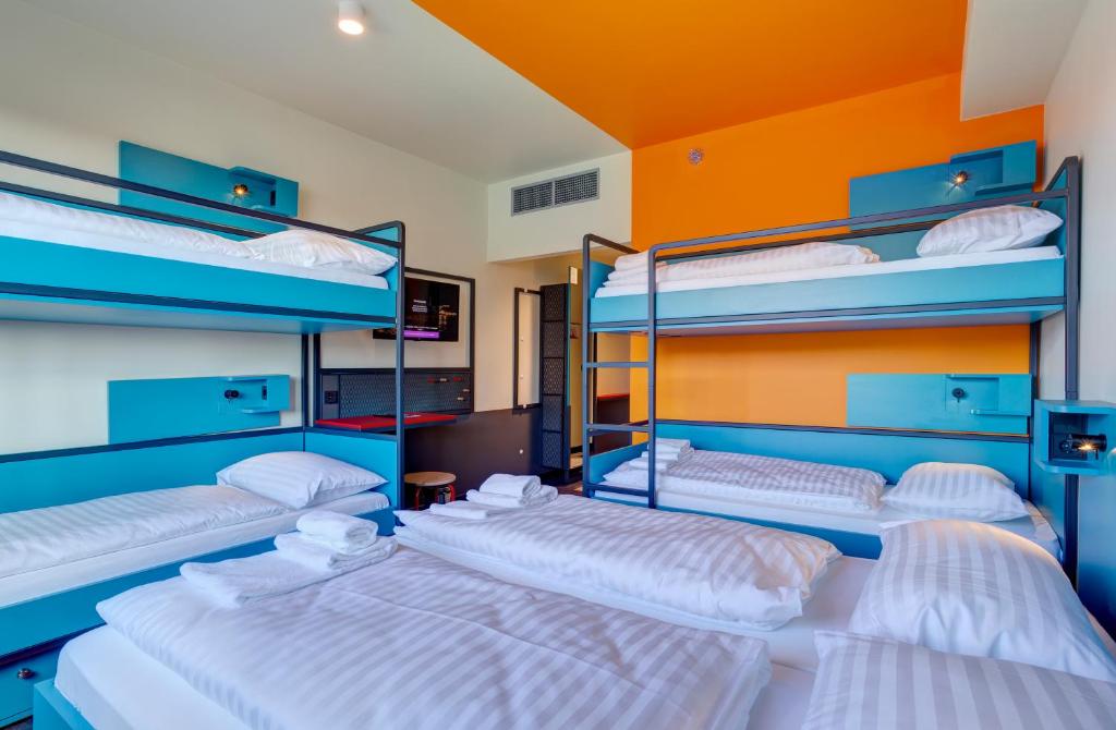 A bed or beds in a room at MEININGER Budapest Great Market Hall