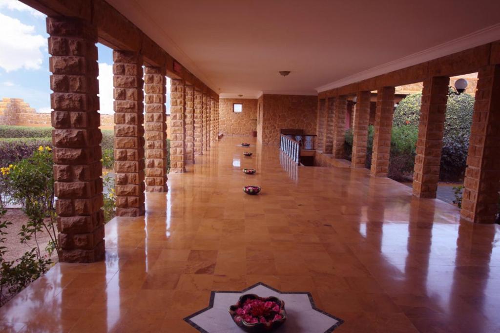a hallway of a house with brick walls and a floor at Hotel Rawalkot Jaisalmer in Jaisalmer