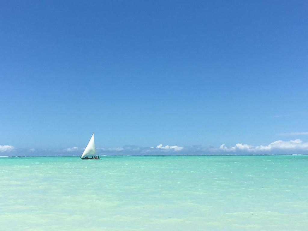 a sail boat in the middle of the ocean at Villa Azzurra in Pwani Mchangani