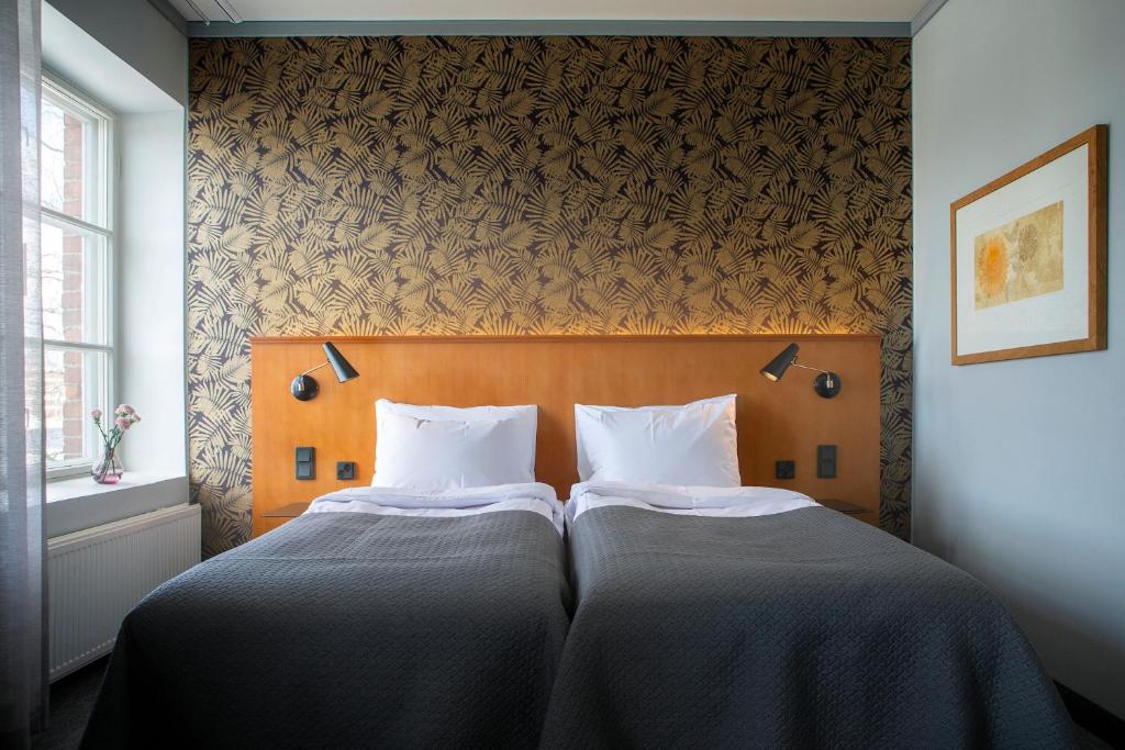 Postel nebo postele na pokoji v ubytování Hotel Lasaretti
