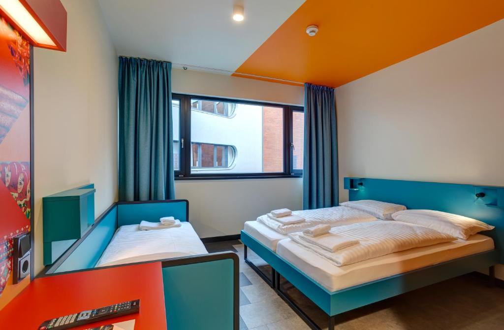 A bed or beds in a room at MEININGER Budapest Great Market Hall