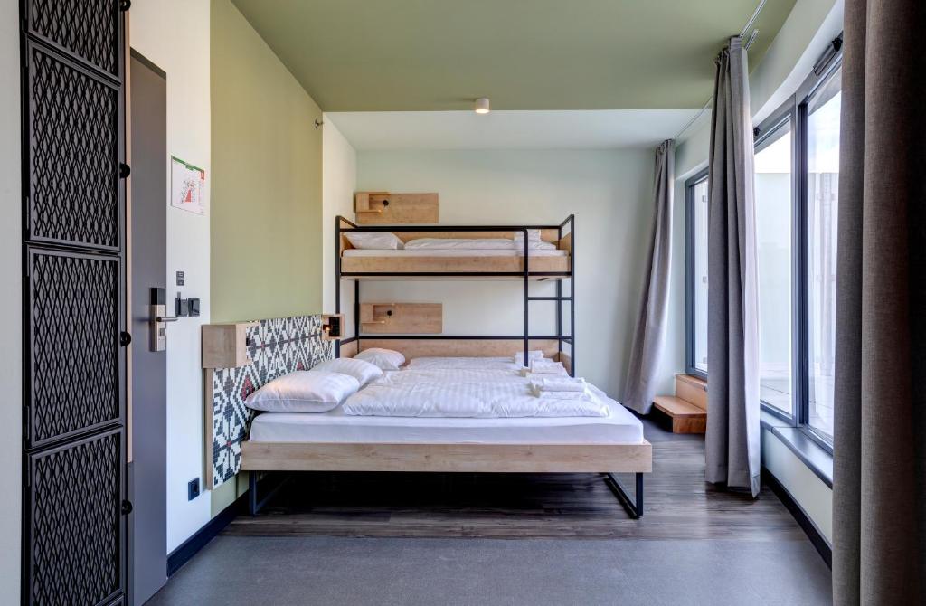 A bed or beds in a room at MEININGER Budapest Great Market Hall