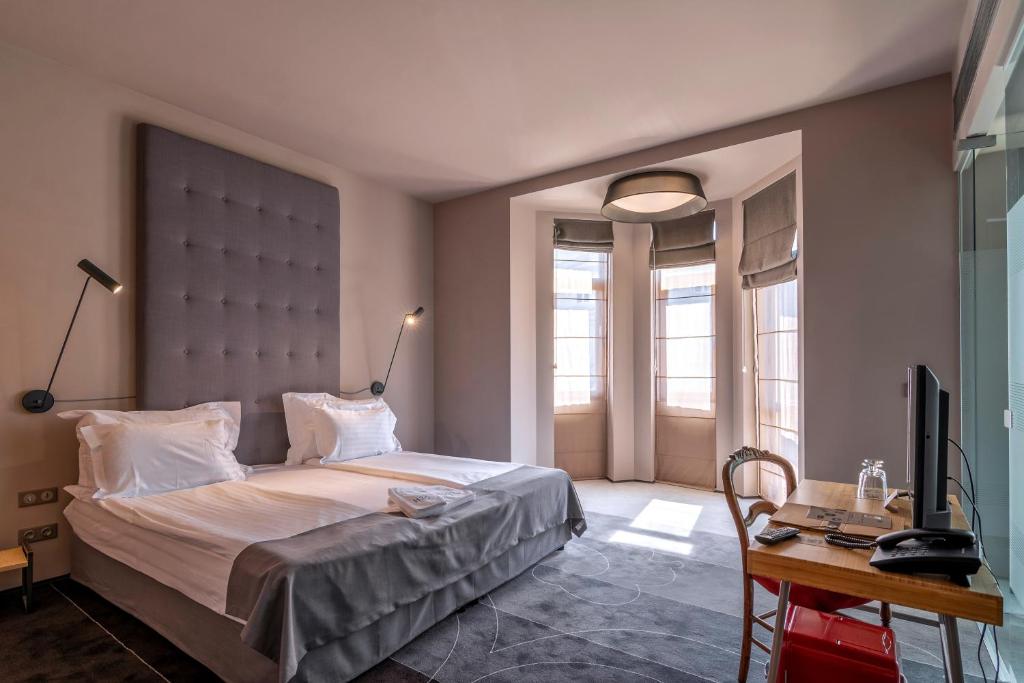 a bedroom with a bed and a desk and a television at Design Hotel 36 in Sofia