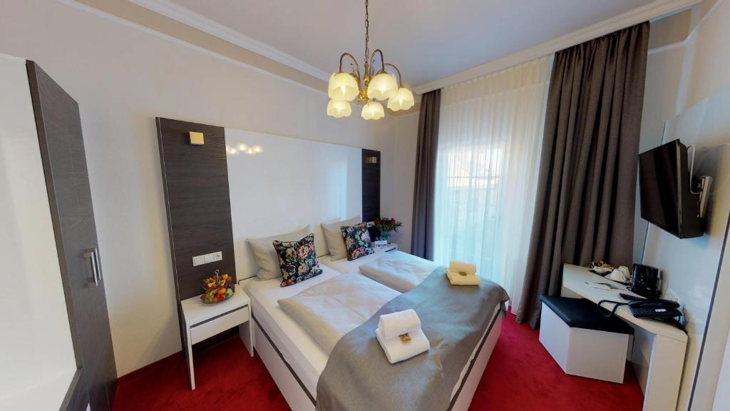 Postel nebo postele na pokoji v ubytování Hotel Residenz23