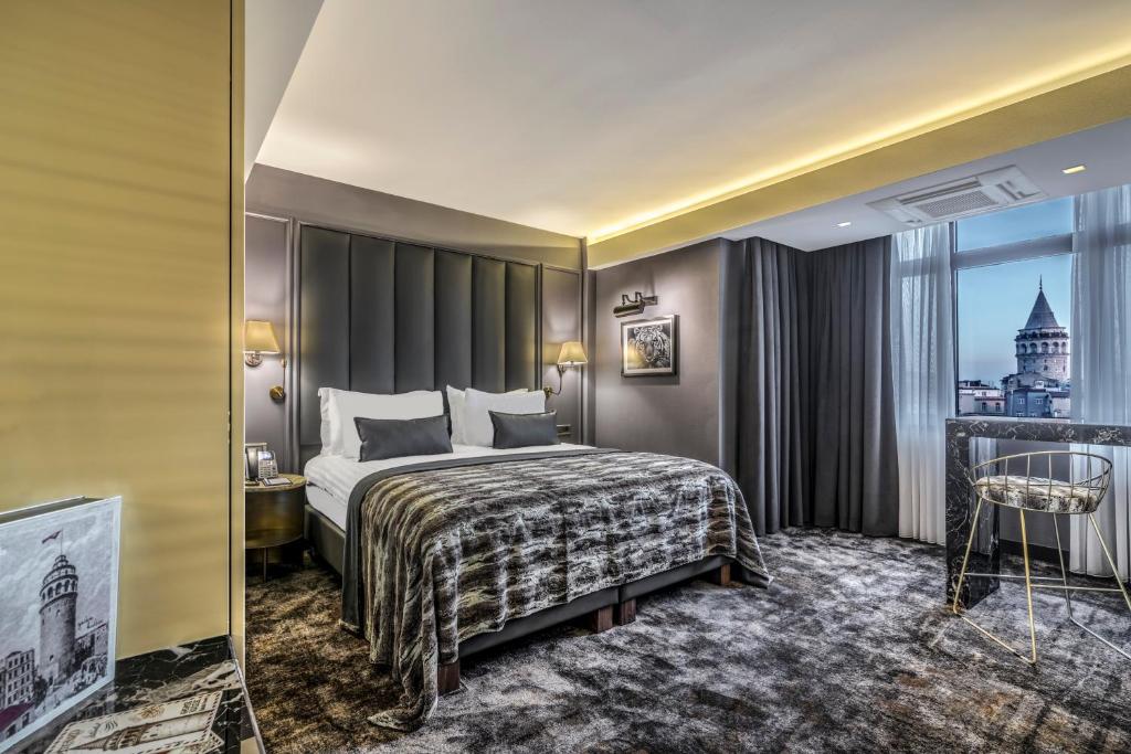 a hotel room with a bed and a window at Galata Times Hotel in Istanbul