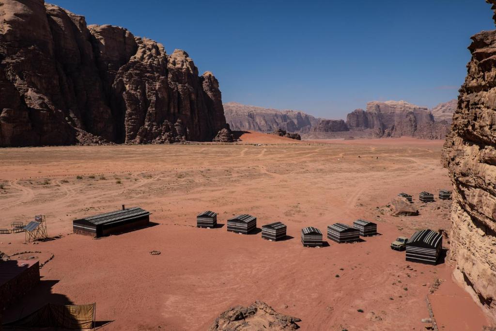 a desert scene with a car and a truck at Arabian Nights in Wadi Rum