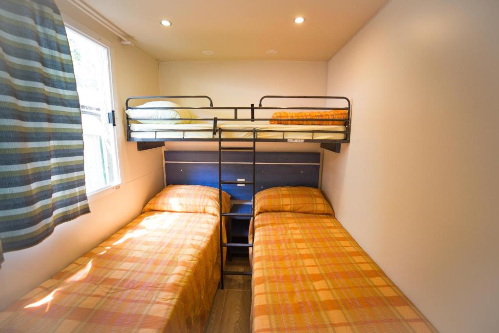A bed or beds in a room at Camping dei Tigli