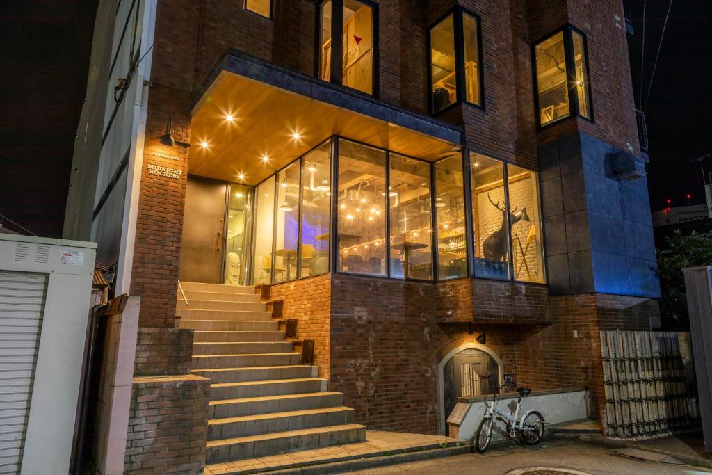 a large brick building with stairs in front of it at Midnight Rockers in Kanazawa