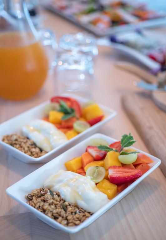three dishes of fruit and nuts on a table at Bentley's Guesthouse in Bloubergstrand