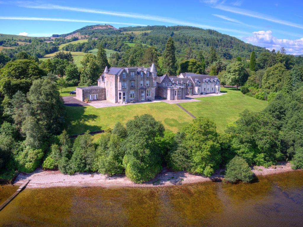 an aerial view of a large house on a hill at No 15 Lomond Castle in Balloch