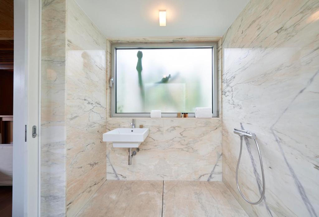a bathroom with a sink and a window at Hotel Porto Santo & Spa in Porto Santo