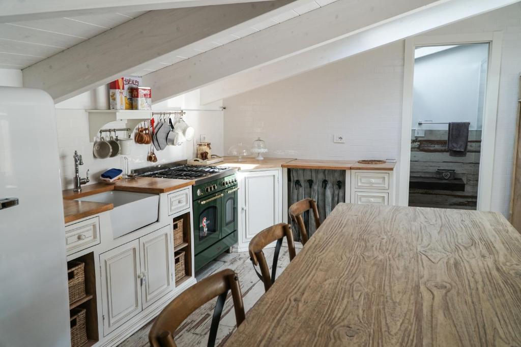 a kitchen with a table with chairs and a stove at Attico 72 in Matera