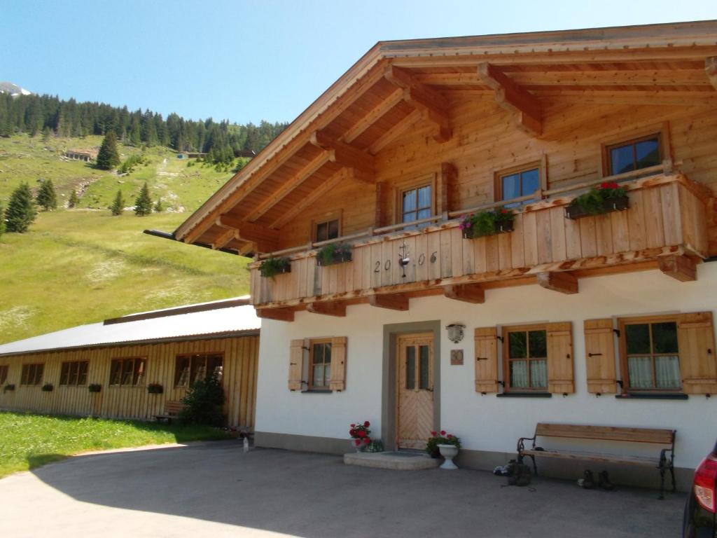 a building with a balcony on top of it at Riepleralm in Matrei in Osttirol