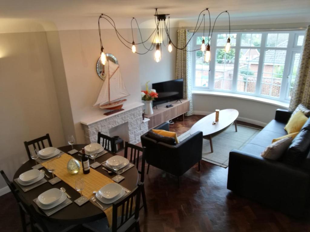 a living room with a table and a dining room at Kings Field Maisonette in Southampton