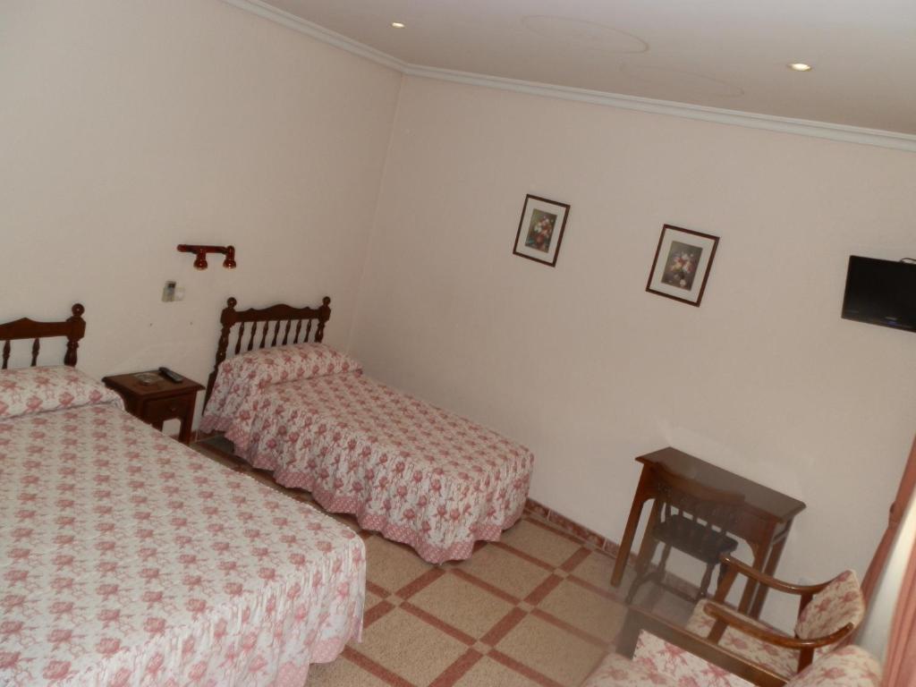 Postel nebo postele na pokoji v ubytování Hostal San Poul