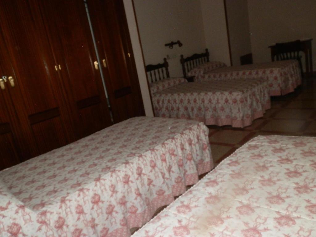 Postel nebo postele na pokoji v ubytování Hostal San Poul