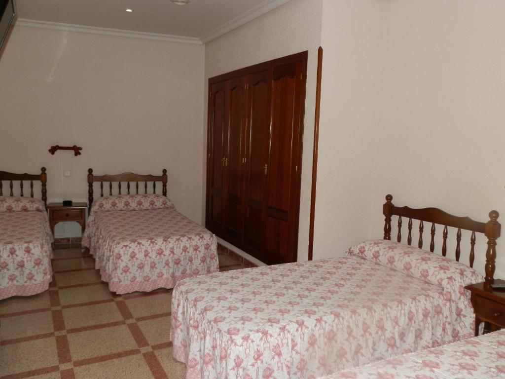 Postel nebo postele na pokoji v ubytování Hostal San Poul