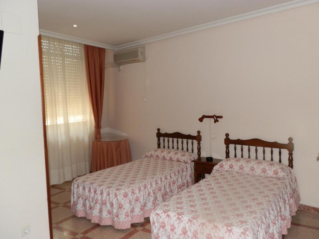 Postel nebo postele na pokoji v ubytování Hostal San Poul