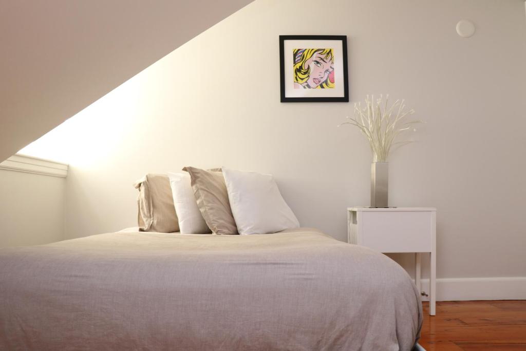 a white bedroom with a bed and a vase at Downtown Beacon Hill, Convenient, Comfy Studio #14 in Boston