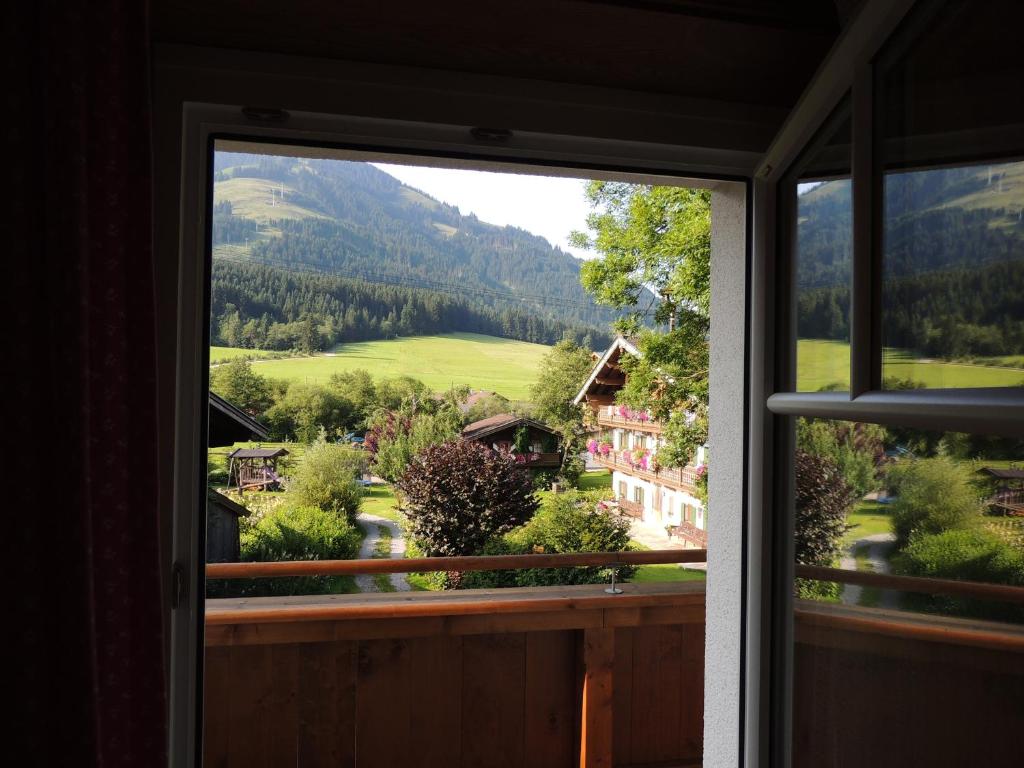 a window view of a mountain view from a house at Pension Rosenhof in Brixen im Thale