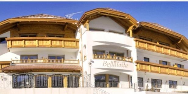 a large white building with a wooden roof at Residence Bellavista in Santa Cristina Gherdëina