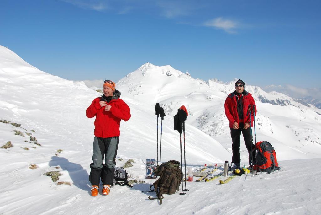 two men standing on top of a snow covered mountain at Pension Rosenhof in Brixen im Thale