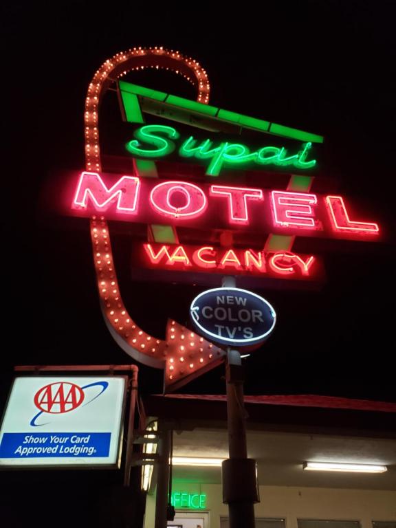 
a neon sign on a neon sign in front of a restaurant at Supai Motel in Seligman
