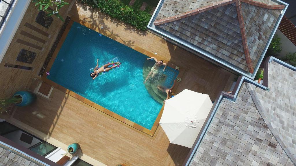an overhead view of a person swimming in a swimming pool at Rawayana West Villas & Kids Park, Formerly Rawai VIP Villas in Rawai Beach