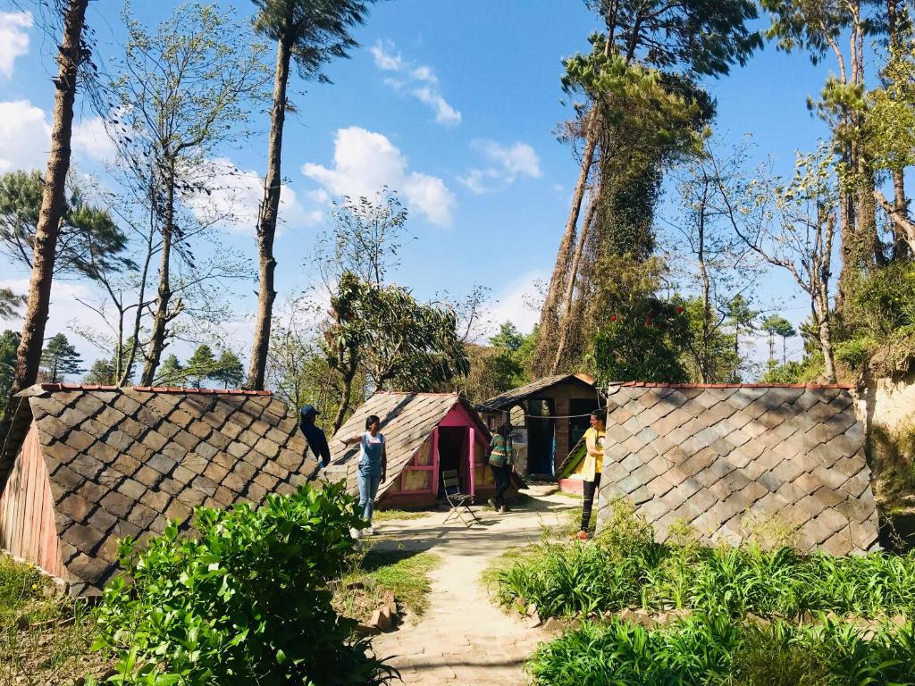 a group of people standing in front of a house at Hotel At The End Of The Universe in Nagarkot