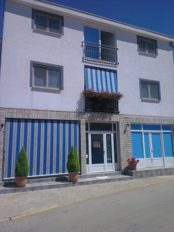 a building with blue and white stripes on it at Maća i Ante Pavlović in Međugorje