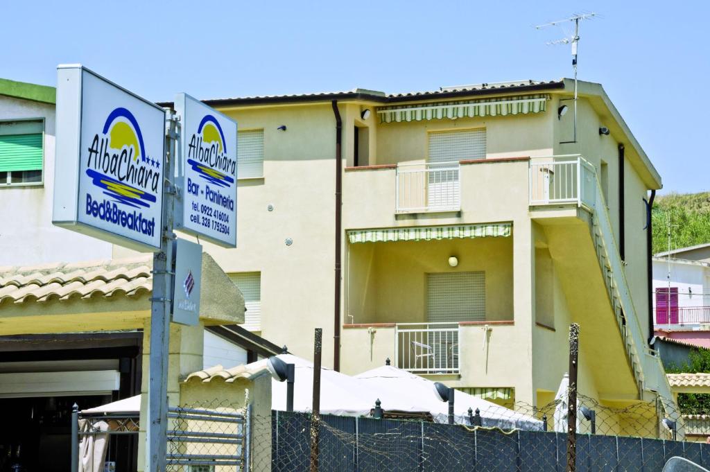 a building with a sign in front of it at B&B Albachiara in San Leone