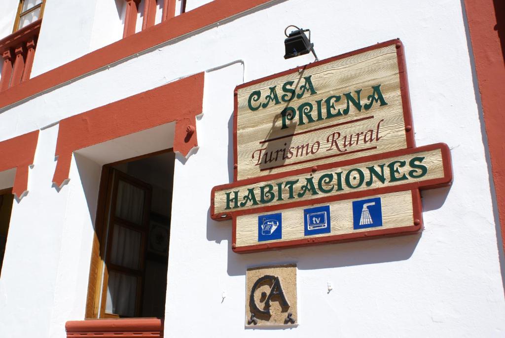 a sign for a restaurant on the side of a building at Casa Rural Priena in Covadonga