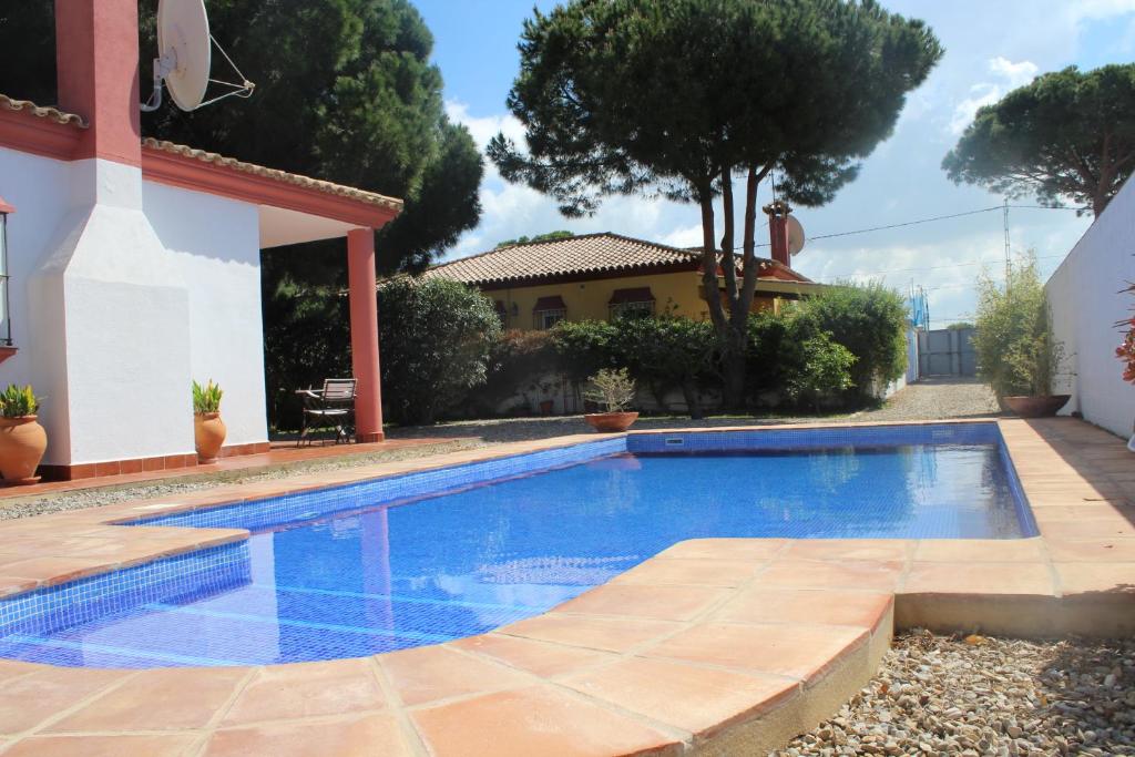 a swimming pool in the backyard of a house at Girasoles in Chiclana de la Frontera