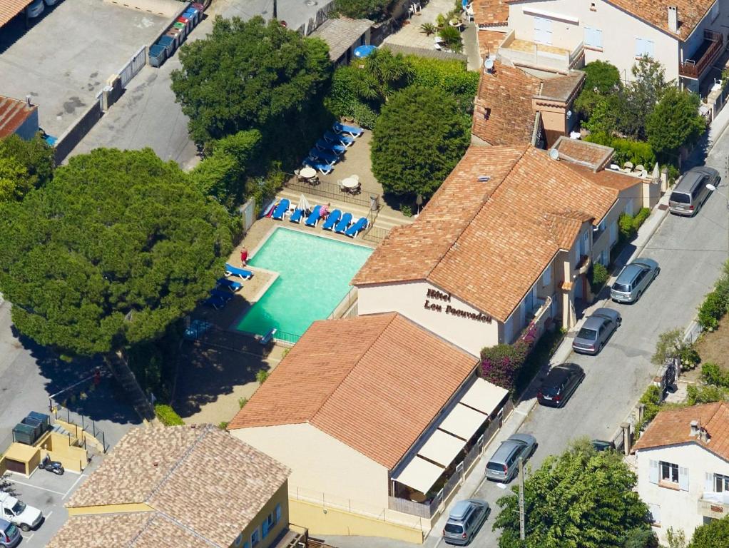 an overhead view of a house with a swimming pool at Hôtel Lou Paouvadou in Sainte-Maxime