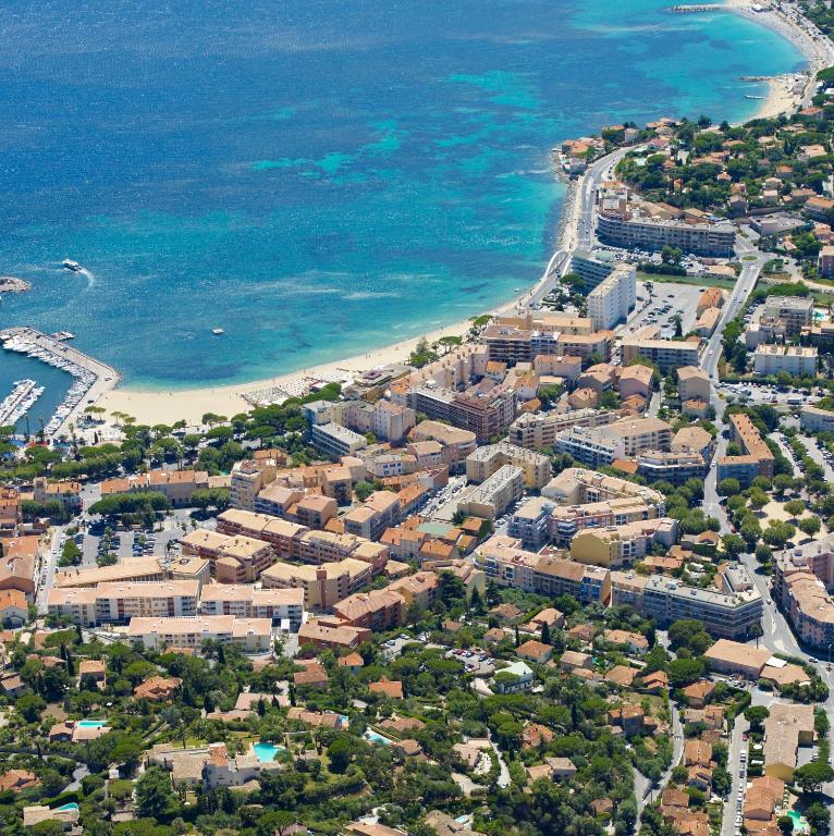 an aerial view of a city and the beach at Hôtel Lou Paouvadou in Sainte-Maxime