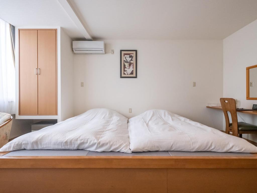 Una cama o camas en una habitación de HAKONE GORA ONSEN Hotel Kasansui