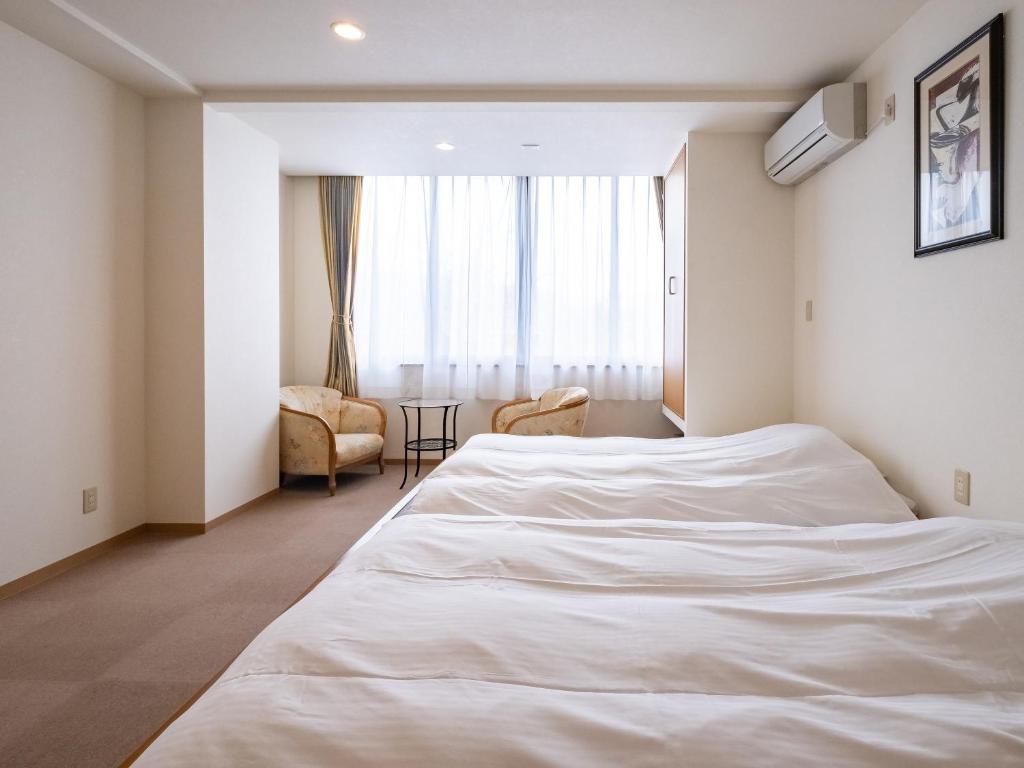 Una cama o camas en una habitación de HAKONE GORA ONSEN Hotel Kasansui