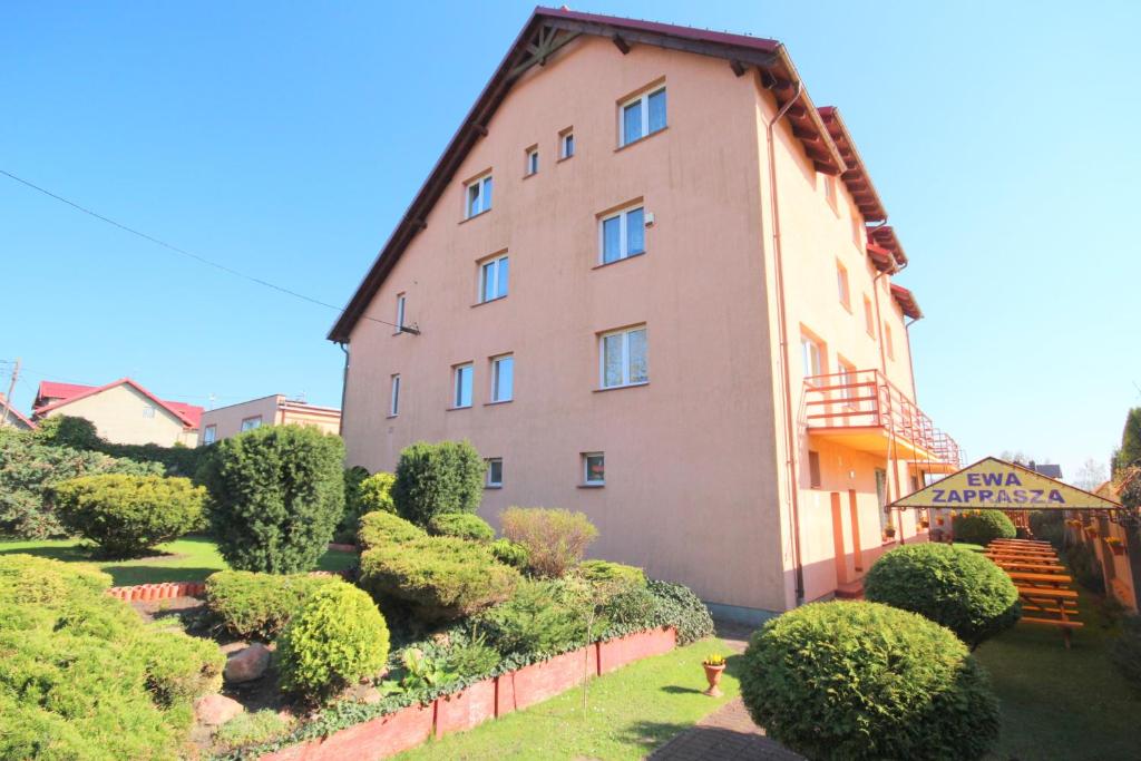 a large building with a bunch of bushes in front of it at Willa Ewa in Jantar