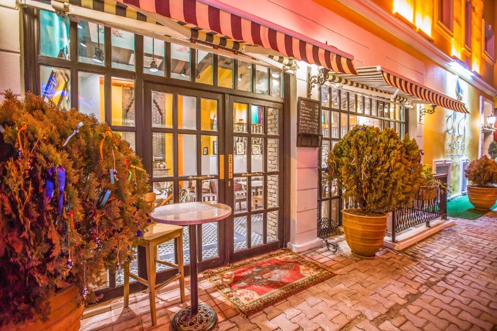 a store front with a table and potted plants at Araf Hotel in Konya