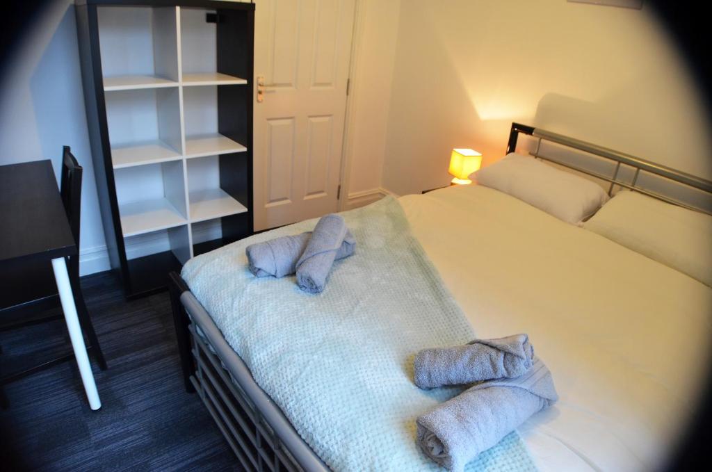 a bedroom with a bed with two towels on it at Old Swan Guest House in Liverpool