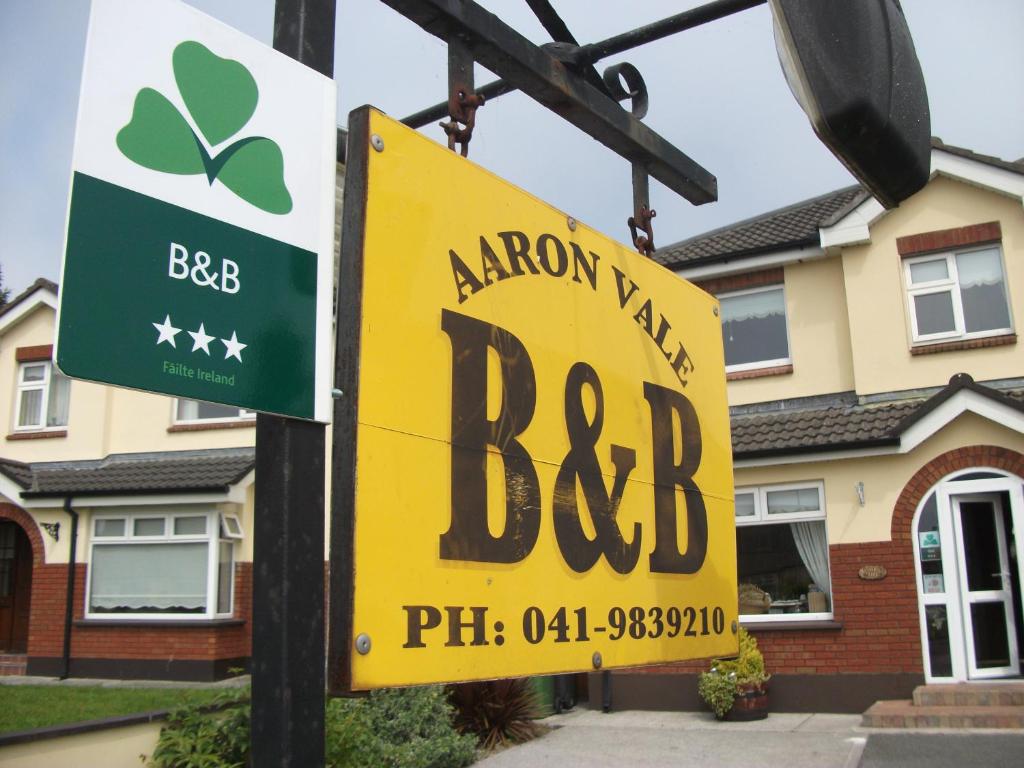 a yellow sign in front of a house at Aaron Vale B&B in Drogheda