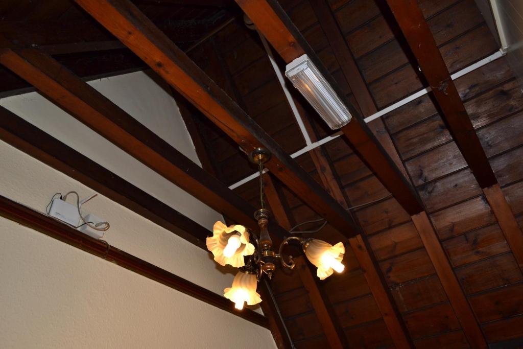 a chandelier is hanging from a wooden ceiling at Croft Hotel in Leicester
