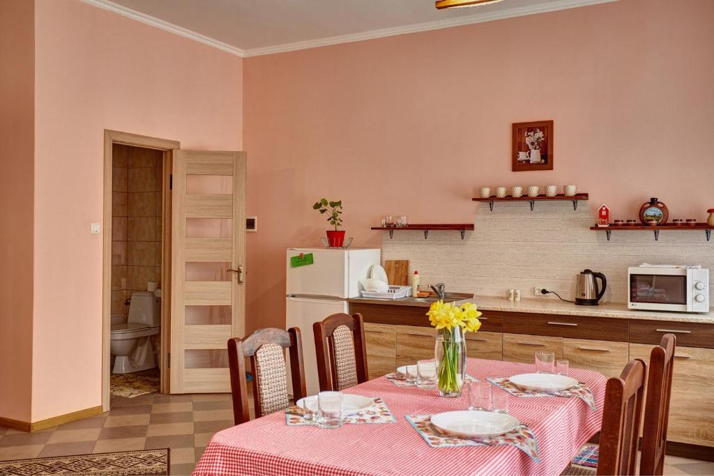 eine Küche und ein Esszimmer mit einem Tisch und Stühlen in der Unterkunft Sweet Home in Kamjanez-Podilskyj