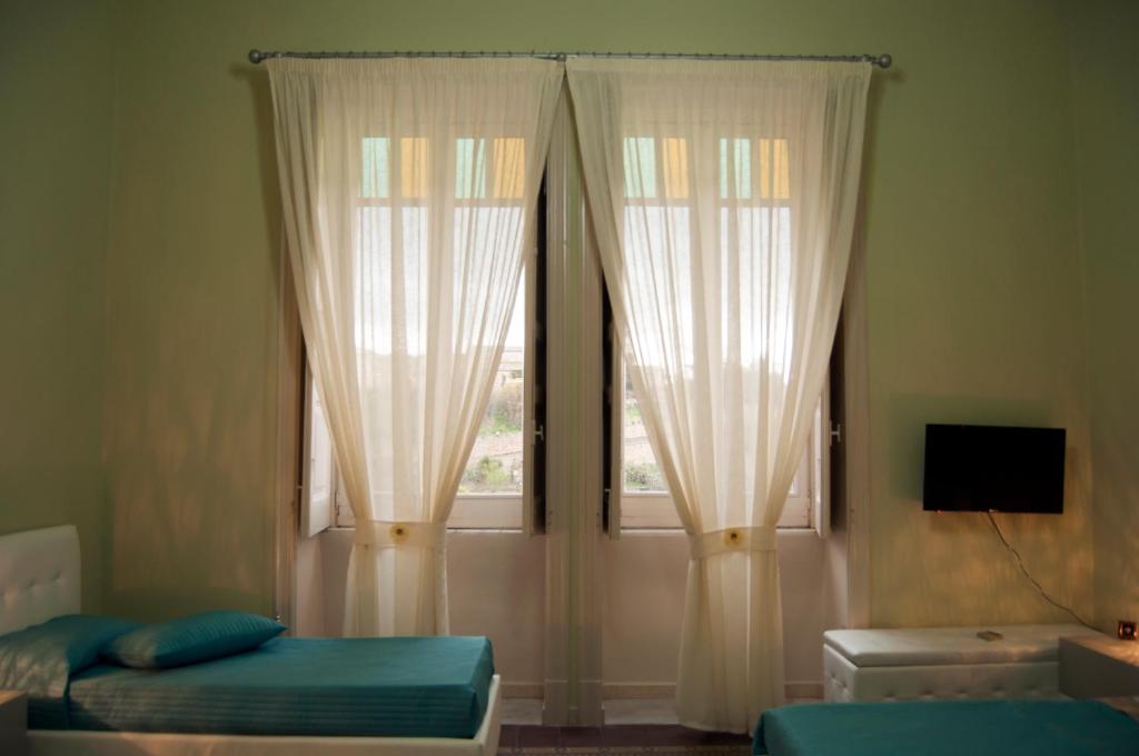 Łóżko lub łóżka w pokoju w obiekcie B&B Villa Roma