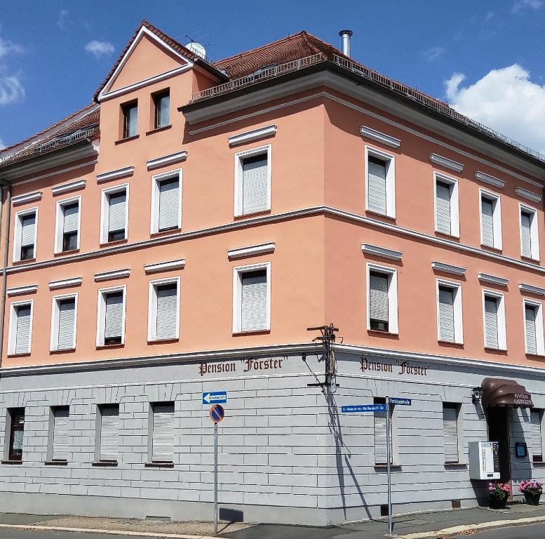 a large orange building on a street corner at Pension Förster in Glauchau