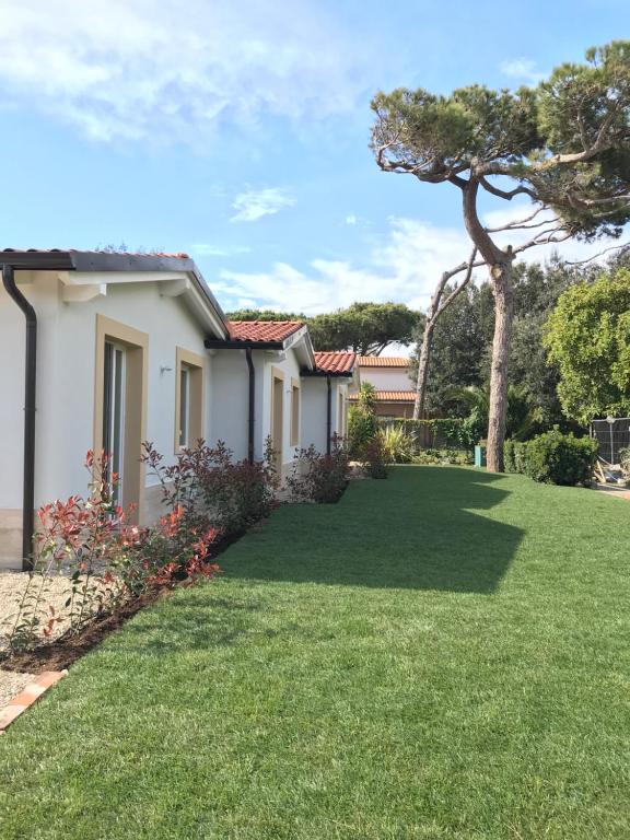 a house with a yard with green grass at Il Miraggio in Fregene