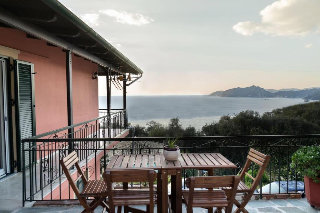 a table and chairs on the balcony of a house at Coralli Pentati 1 "Dimitris Apartments" in Pentátion