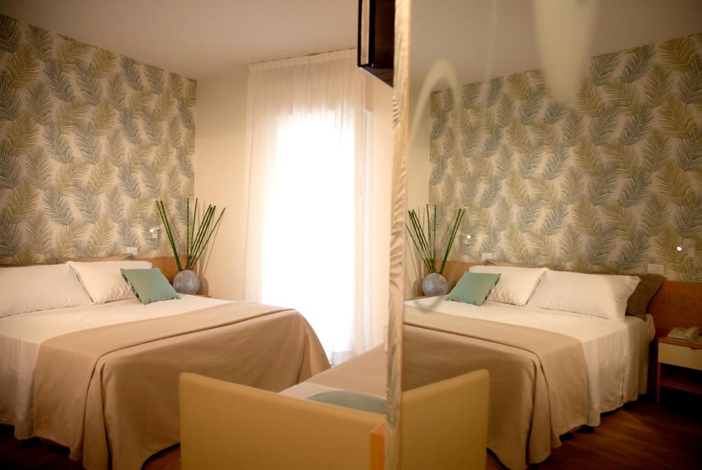 Postel nebo postele na pokoji v ubytování Hotel Montecarlo - Vista Mare con Piscina & Area Fitness